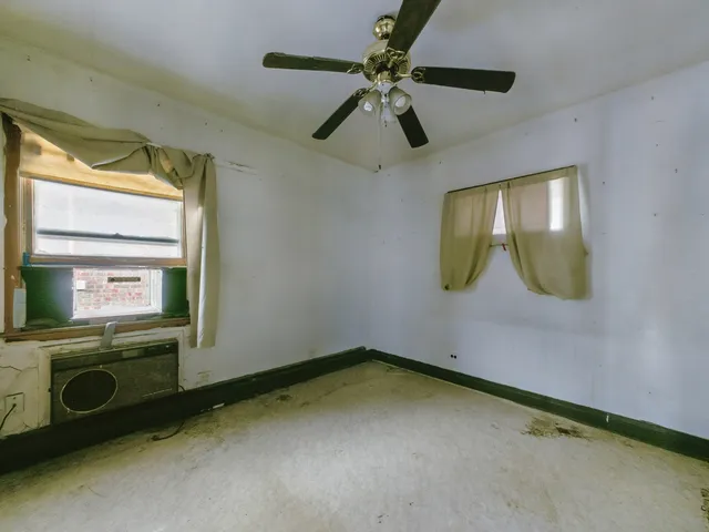 a view of a room with a mirror and a ceiling fan