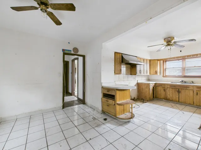 a kitchen with a refrigerator a oven and a sink
