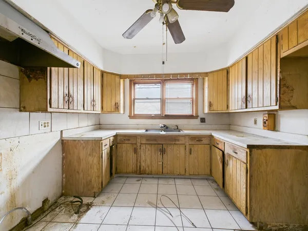 a kitchen with a sink a stove a microwave and cabinets