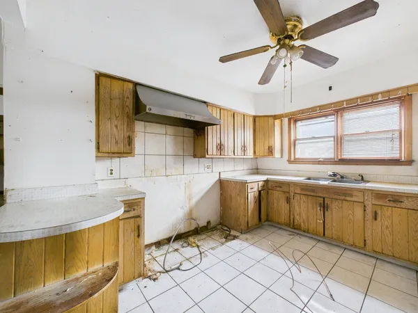 a large kitchen with a large window cabinets and stainless steel appliances
