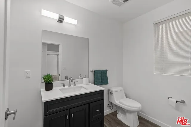 a bathroom with a sink toilet and a mirror