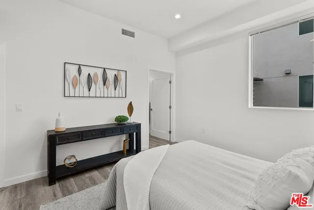 a bedroom with a bed and paintings on the wall