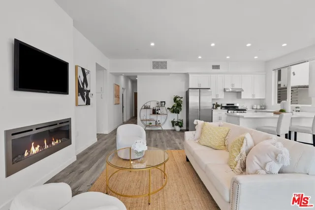 a living room with fireplace furniture and a flat screen tv