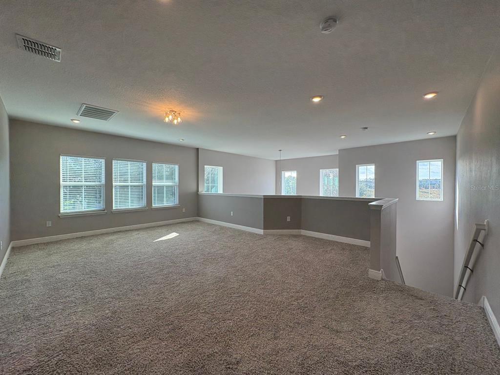 9640 Amber Chestnut Way Winter Garden, FL 34787 - Photo 13 of 32 a view of an empty room with a window
