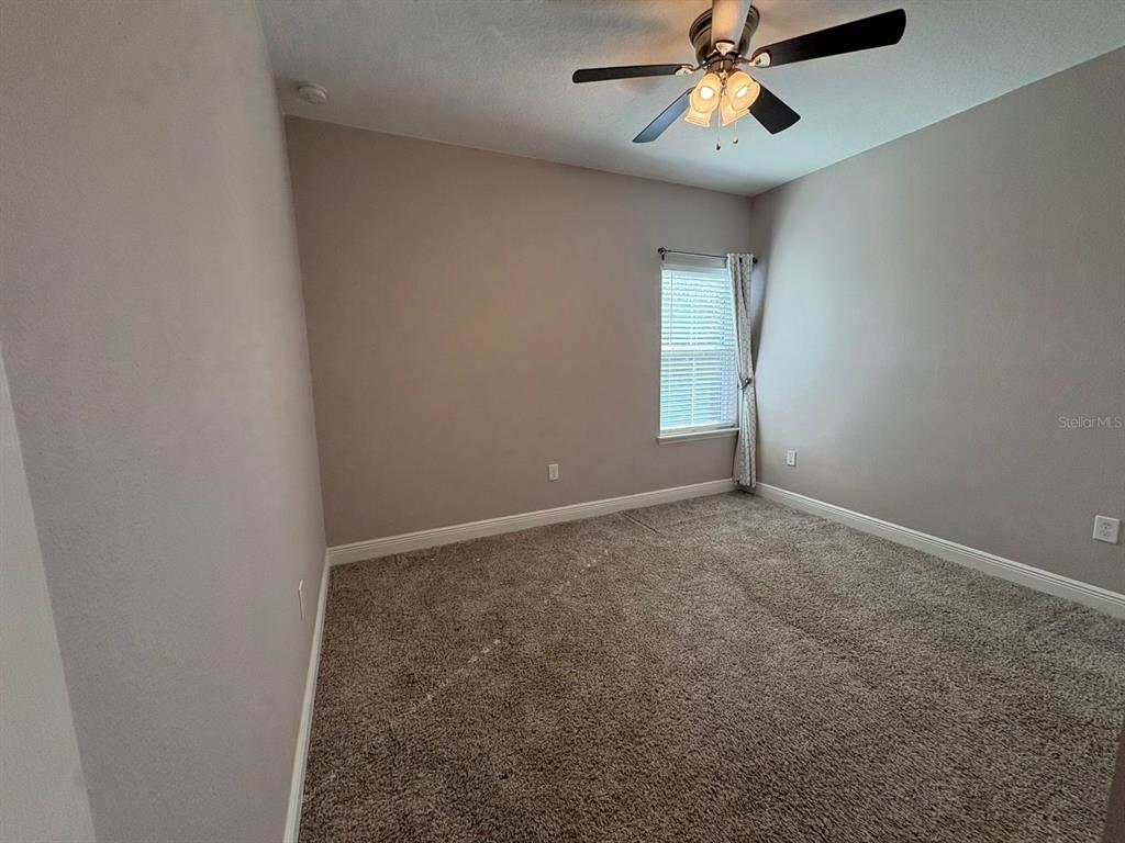 9640 Amber Chestnut Way Winter Garden, FL 34787 - Photo 15 of 32 an empty room with windows and fan