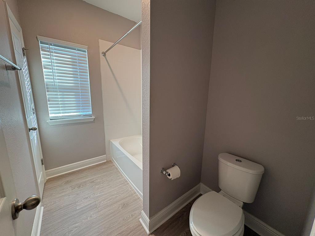 9640 Amber Chestnut Way Winter Garden, FL 34787 - Photo 18 of 32 a bathroom with a toilet and a shower