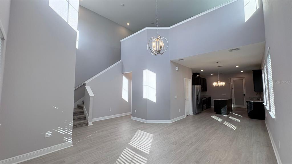 9640 Amber Chestnut Way Winter Garden, FL 34787 - Photo 2 of 32 a view of a hallway with entryway and wooden floor