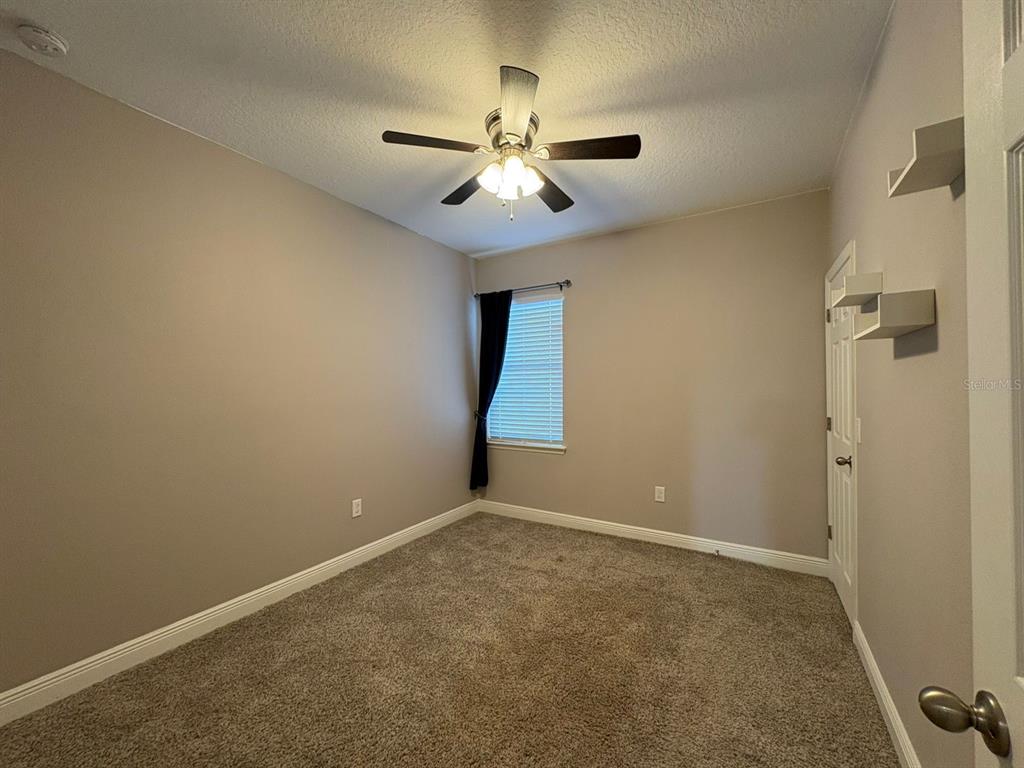 9640 Amber Chestnut Way Winter Garden, FL 34787 - Photo 22 of 32 an empty room with closet and a chandelier fan