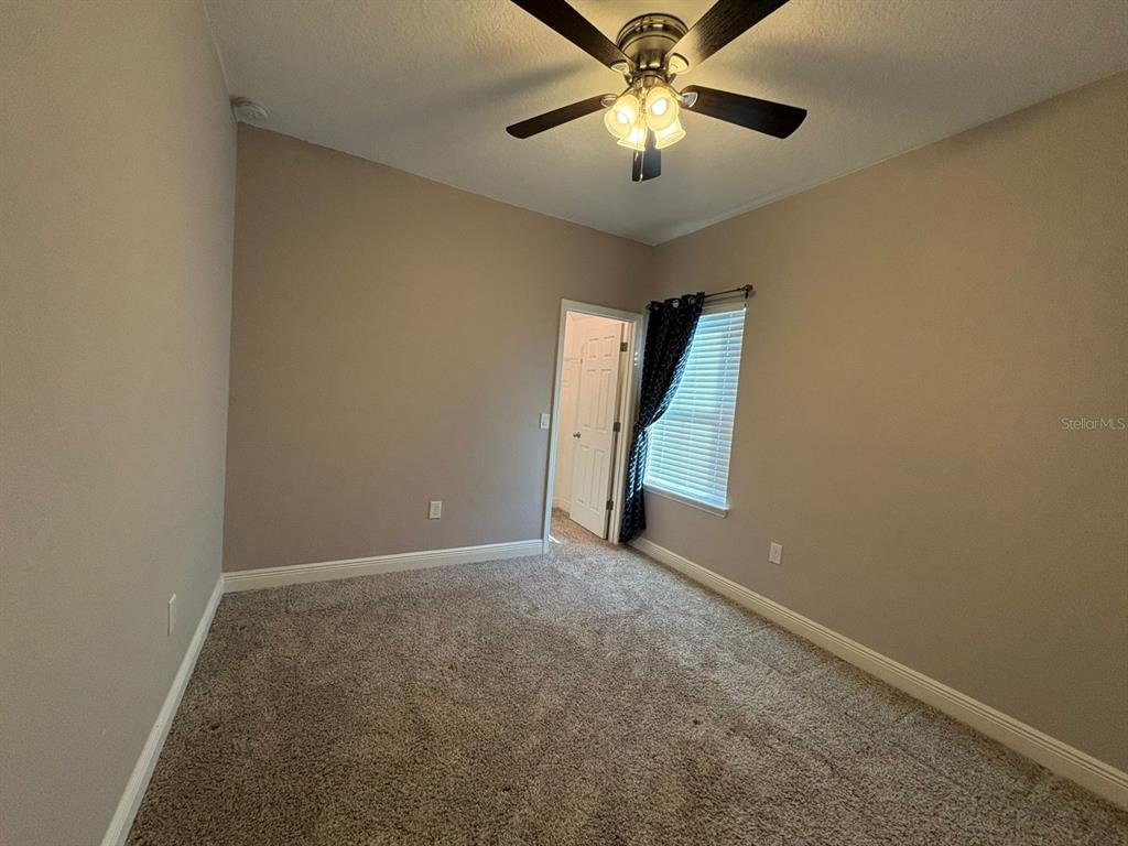 9640 Amber Chestnut Way Winter Garden, FL 34787 - Photo 23 of 32 an empty room with windows and fan