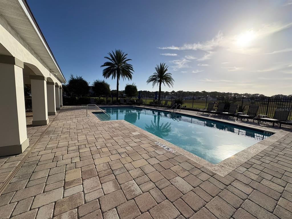 9640 Amber Chestnut Way Winter Garden, FL 34787 - Photo 25 of 32 a swimming pool with outdoor seating