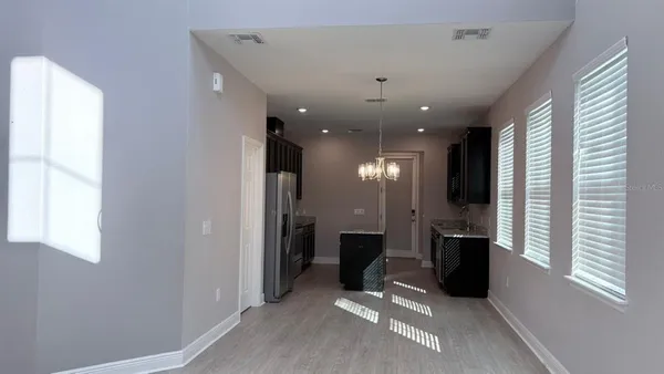 a kitchen with stainless steel appliances granite countertop a sink refrigerator and microwave