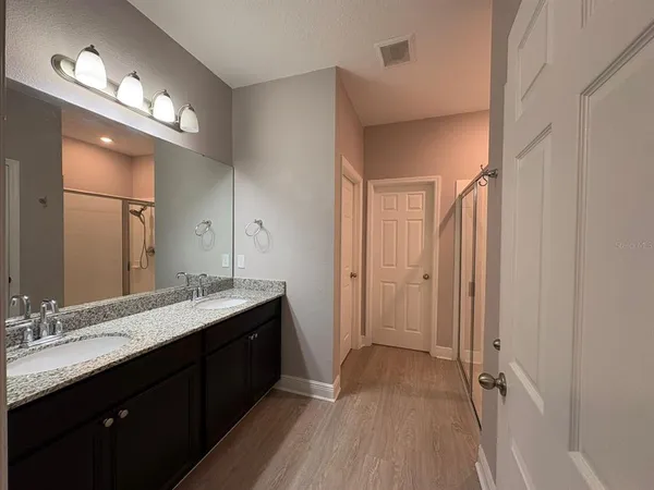 a view of an empty room with a chandelier fan