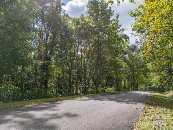 a view of a field with trees in front of it
