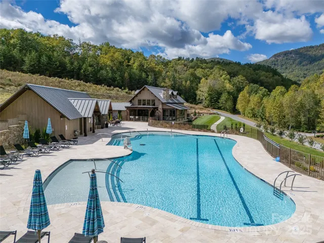 a view of house with outdoor space swimming pool and furniture