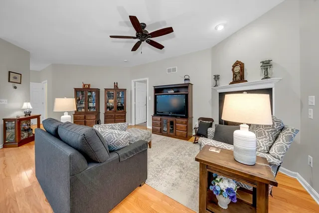 a living room with furniture a rug and a flat screen tv