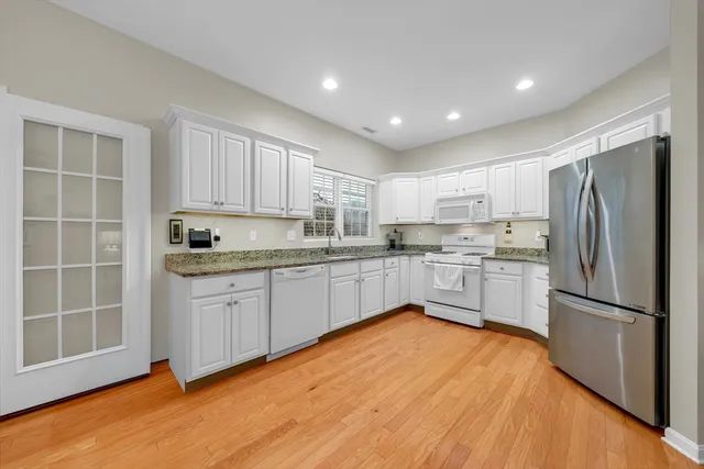 a kitchen with a refrigerator a sink and cabinets
