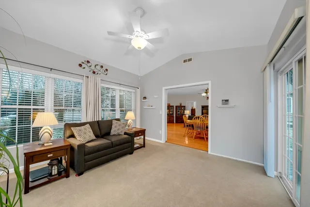 a living room with furniture and a chandelier