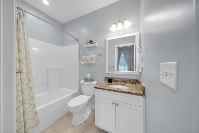 a bathroom with a granite countertop sink toilet a large mirror and shower