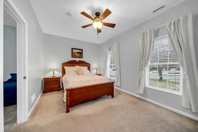 a bedroom with a bed and window