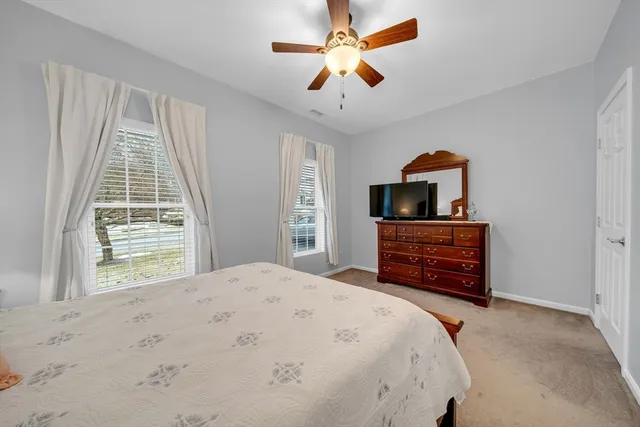 a bedroom with a bed dresser and a window