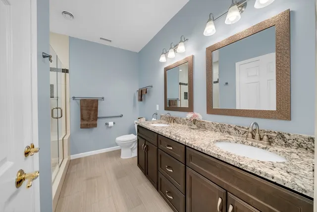 a spacious bathroom with a granite countertop sink mirror and a bathtub