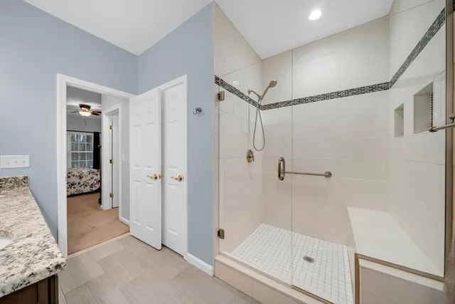 a bathroom with a shower and a glass door
