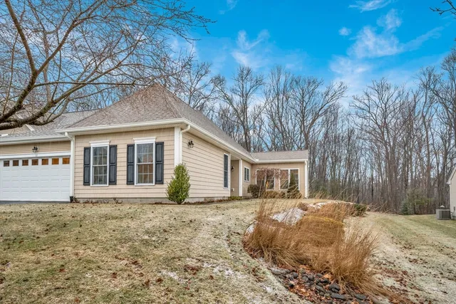 a view of a house with a yard covered in snow