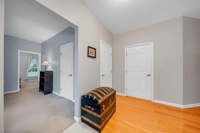 a living room with a bed and dresser