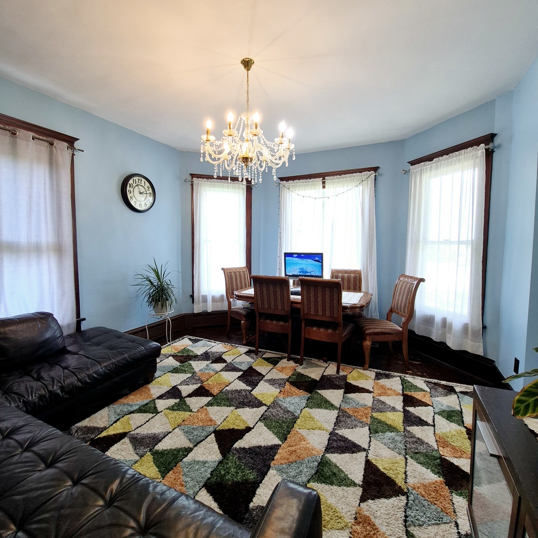 305 East Jackson Street Cullom, IL 60929 - Photo 3 of 23 a bed room with a bed and a chandelier