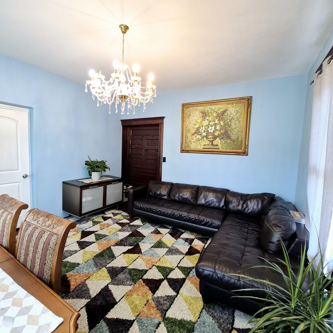 305 East Jackson Street Cullom, IL 60929 - Photo 4 of 23 a bedroom with a bed dresser and a chandelier