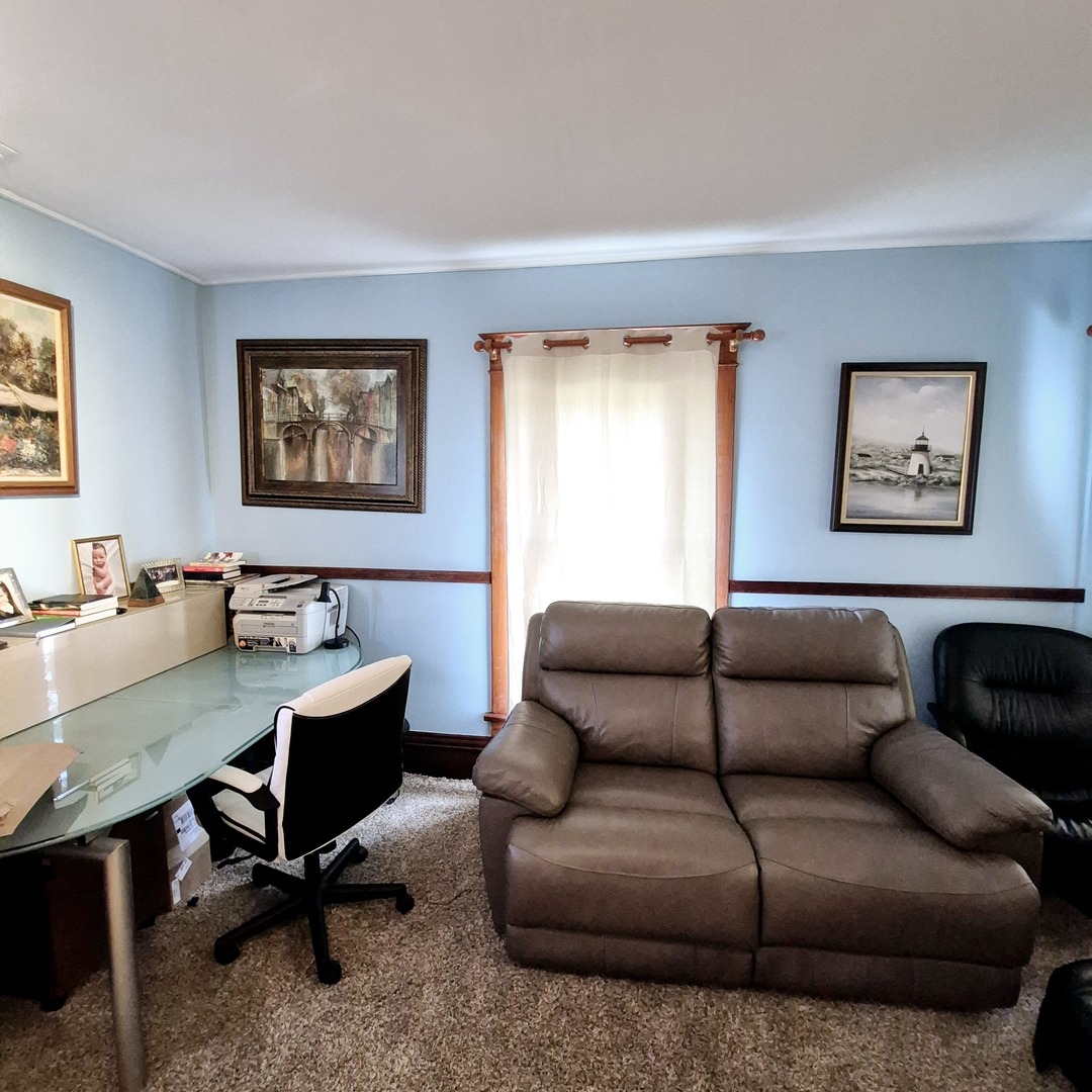 305 East Jackson Street Cullom, IL 60929 - Photo 5 of 23 a view of a livingroom with workspace and a couch