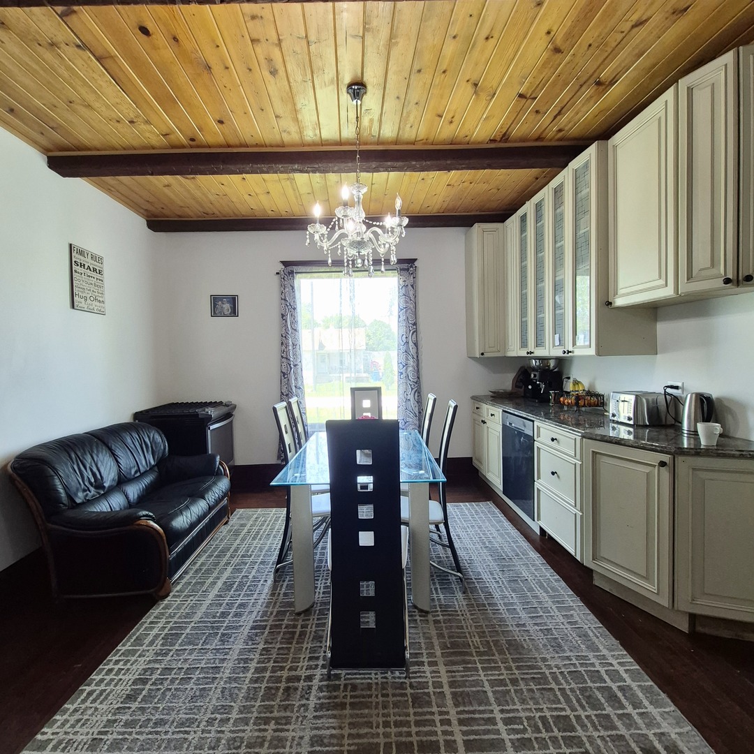 305 East Jackson Street Cullom, IL 60929 - Photo 7 of 23 a living room with furniture and a chandelier