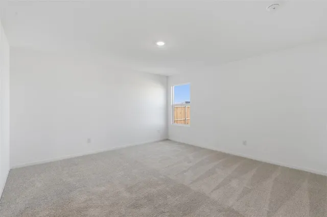 a view of an empty room and a window