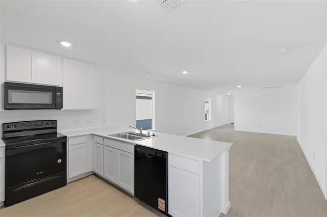 a kitchen with a sink stove and microwave