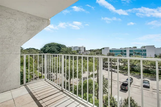 a view of a balcony with yard