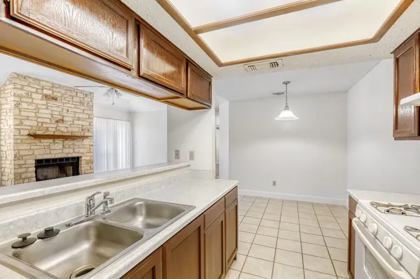 a kitchen with a sink cabinets and appliances