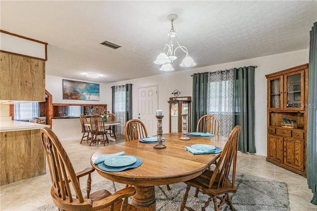 1453 Creek Road Wesley Chapel, FL 33543 - Photo 11 of 26 a dining room with furniture and window