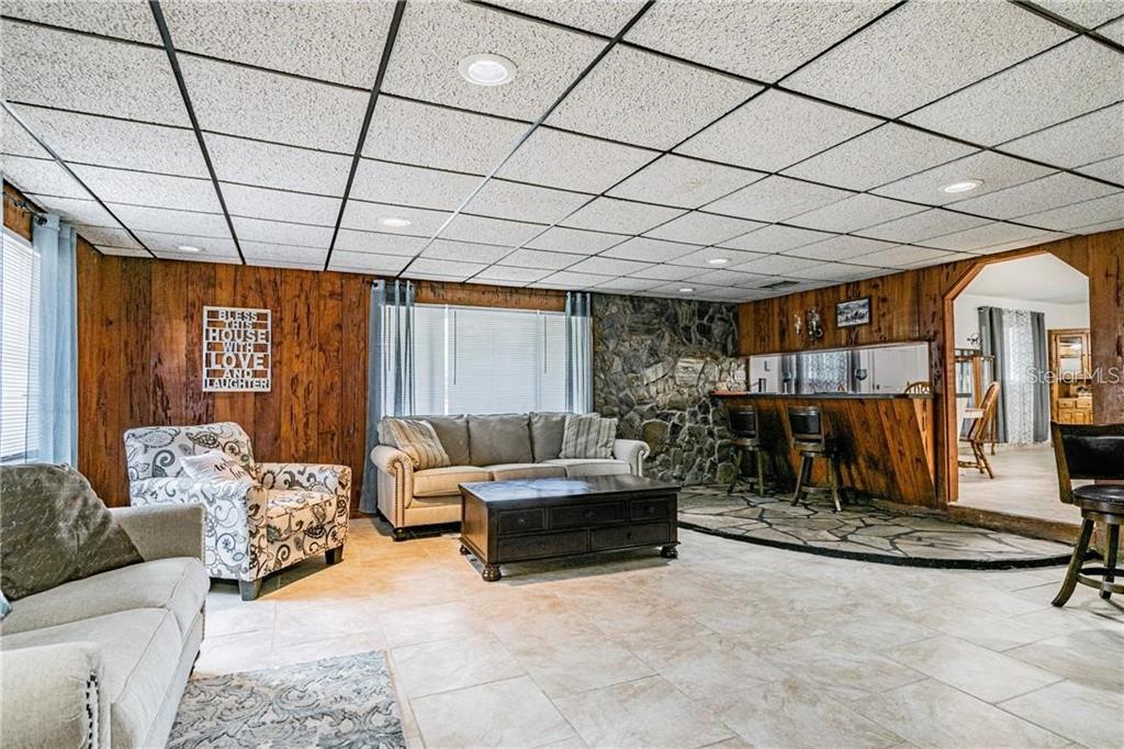 1453 Creek Road Wesley Chapel, FL 33543 - Photo 17 of 26 a living room with furniture and a flat screen tv