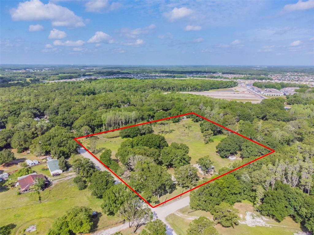 1453 Creek Road Wesley Chapel, FL 33543 - Photo 24 of 26 an aerial view of a golf course with an outdoor space