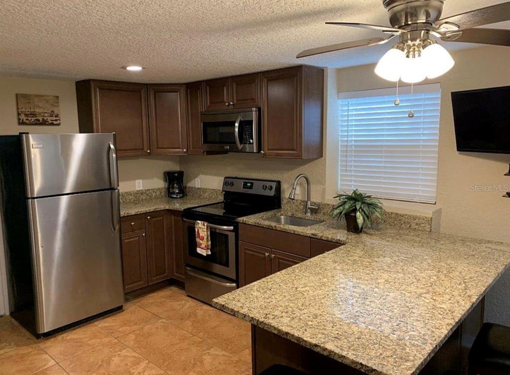 2512 Musselwhite Avenue, Unit 3 Orlando, FL 32804 - Photo 2 of 9 a kitchen with a refrigerator and a sink