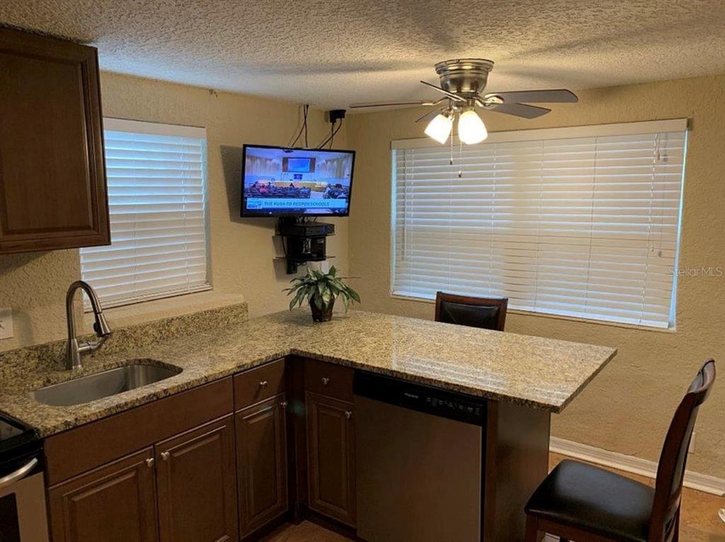 2512 Musselwhite Avenue, Unit 3 Orlando, FL 32804 - Photo 3 of 9 a kitchen with a sink cabinets and a window