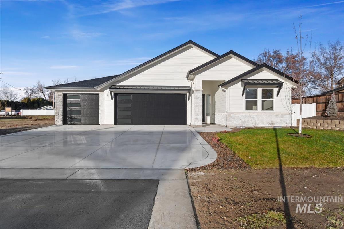 357 West Flour Mill Middleton, ID 83644 - Photo 2 of 49 View of front of house with concrete driveway, an attached garage, and stone siding