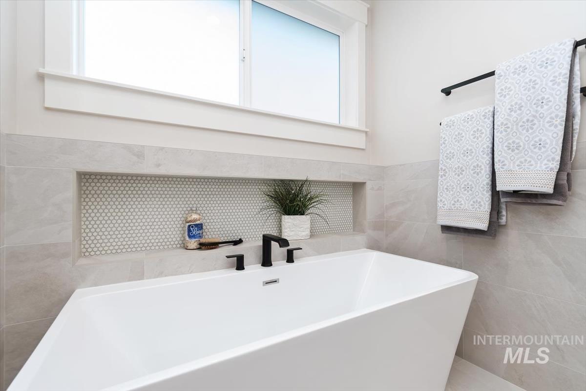 357 West Flour Mill Middleton, ID 83644 - Photo 27 of 49 Bathroom with a soaking tub and tile walls