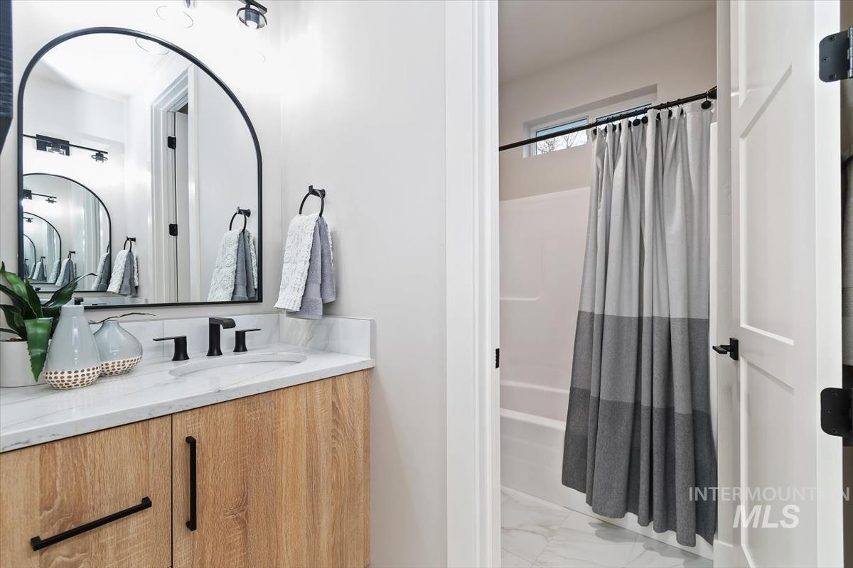 357 West Flour Mill Middleton, ID 83644 - Photo 28 of 49 Bathroom with shower / tub combo with curtain, vanity, and light marble finish flooring
