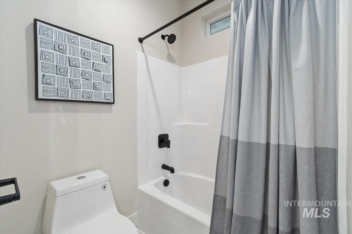 357 West Flour Mill Middleton, ID 83644 - Photo 33 of 49 Bathroom featuring shower / bath combo with shower curtain and toilet
