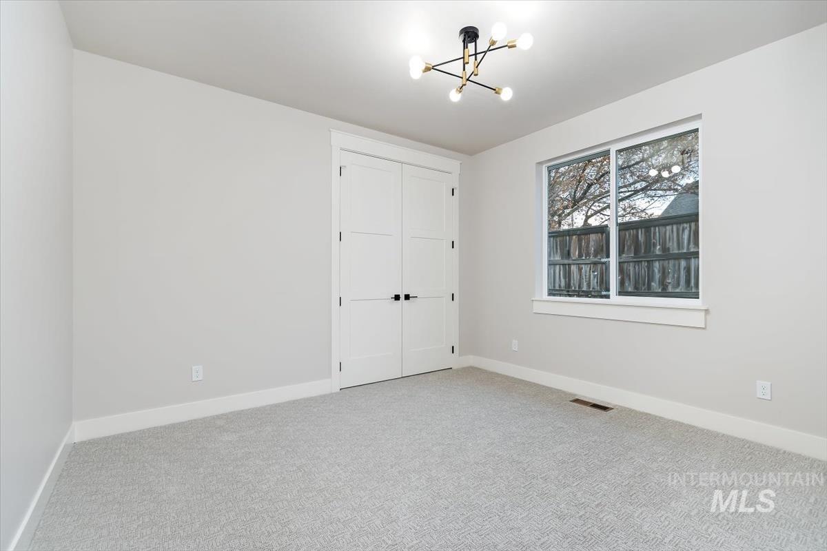357 West Flour Mill Middleton, ID 83644 - Photo 36 of 49 Unfurnished bedroom with carpet floors, a closet, and hanging lights