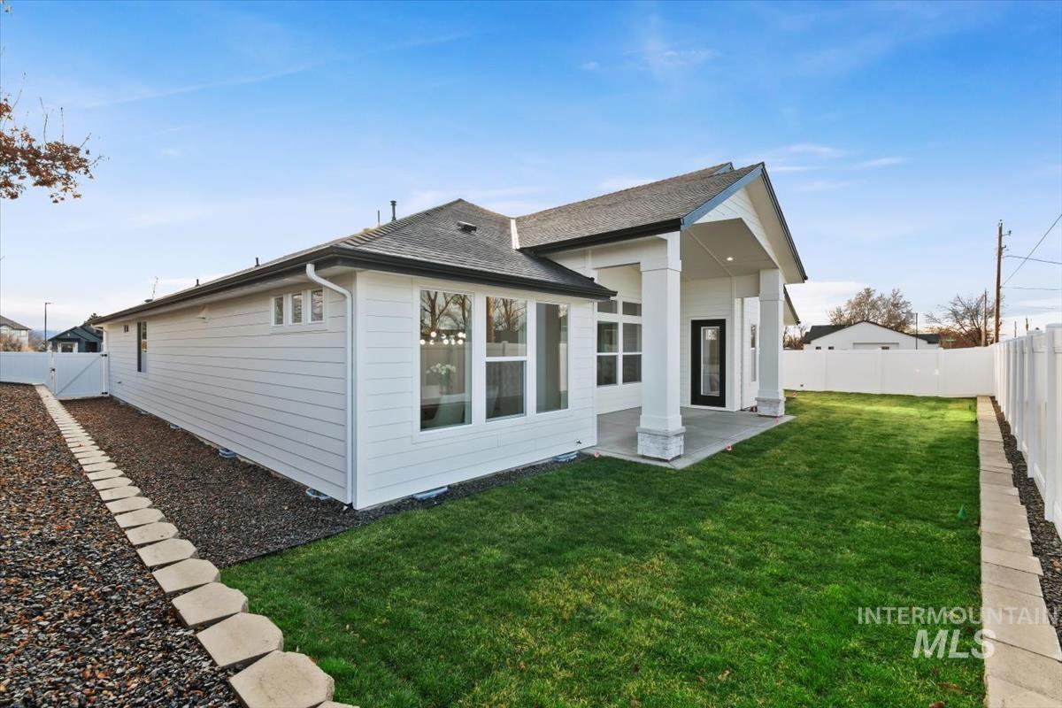 357 West Flour Mill Middleton, ID 83644 - Photo 39 of 49 Rear view of house with a fenced backyard, a patio, roof with shingles, and a gate