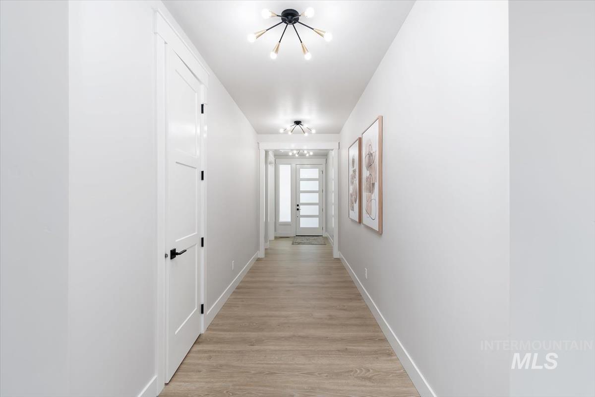 357 West Flour Mill Middleton, ID 83644 - Photo 4 of 49 Corridor with light wood finished floors and suspended lighting