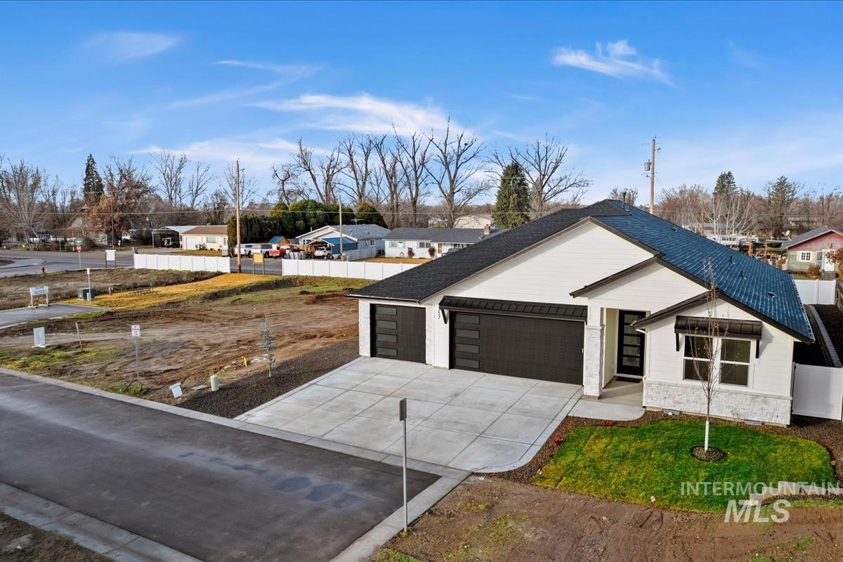 357 West Flour Mill Middleton, ID 83644 - Photo 43 of 49 View of front of house with a residential view, driveway, and an attached garage