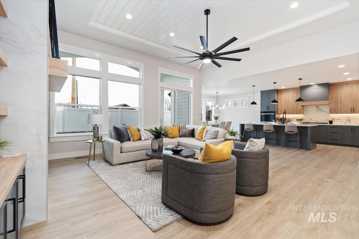 357 West Flour Mill Middleton, ID 83644 - Photo 5 of 49 Living area featuring light wood-type flooring, ceiling fan, a chandelier, and a raised ceiling